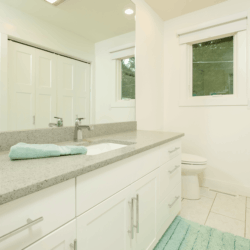 white and blue bathroom with custom cabinets 