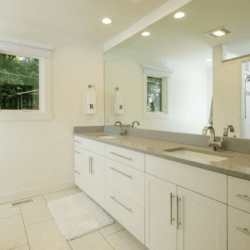 white and blue bathroom with custom cabinets from right