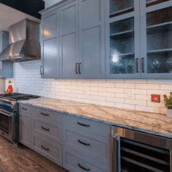 Grey Cabinets with white kitchen backsplash 