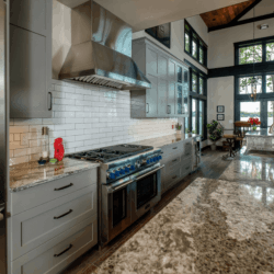 Grey Cabinets with white backsplash from the left